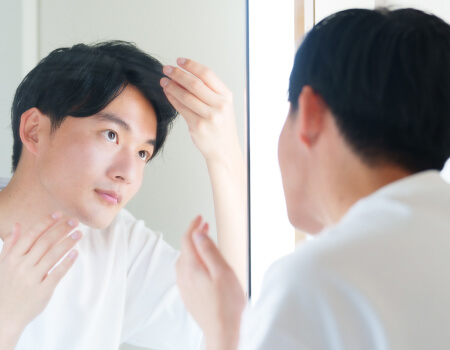 鏡を見る男性